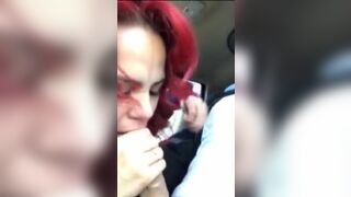 Redhead swallowing a big load of cum in the car.