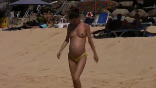 Pregnant and nude babe at the beach