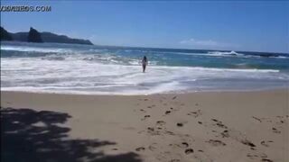 Hot girl on the beach taking off her bikini