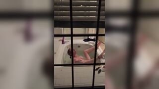 Dude filming his sister stimulating her pussy in the bathtub.