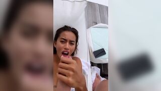 Little Thai beauty stroking a big cock to ejaculation.