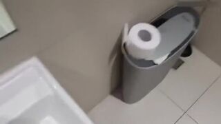 Beautiful teen babe masturbates on the public toilet