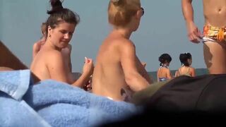 Beautiful busty topless woman filmed by voyeur on the beach