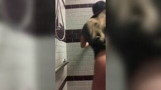Sexy American young having fun in a public toilet