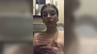 Sexy cutie teasing her nipples on the toilet