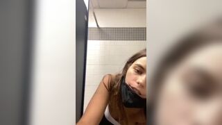 Gorgeous cute young teasing in an empty public toilet