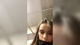 Gorgeous cute young teasing in an empty public toilet